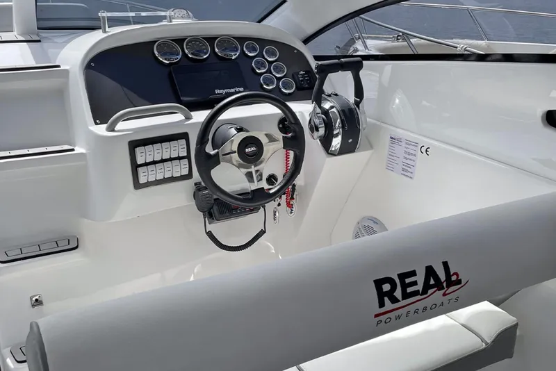 Slide: The Image of Real 35 Special Deck (SD) 2023 boat cockpit with steering wheel and control panel. - 9