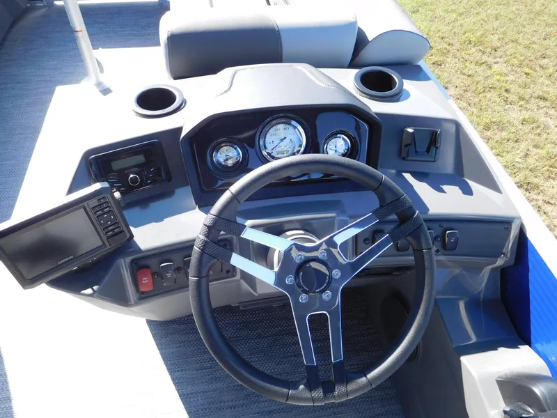 Slide: The Image of 2024 Bennington 22 SVSR boat dashboard with steering wheel and gauges. - 2