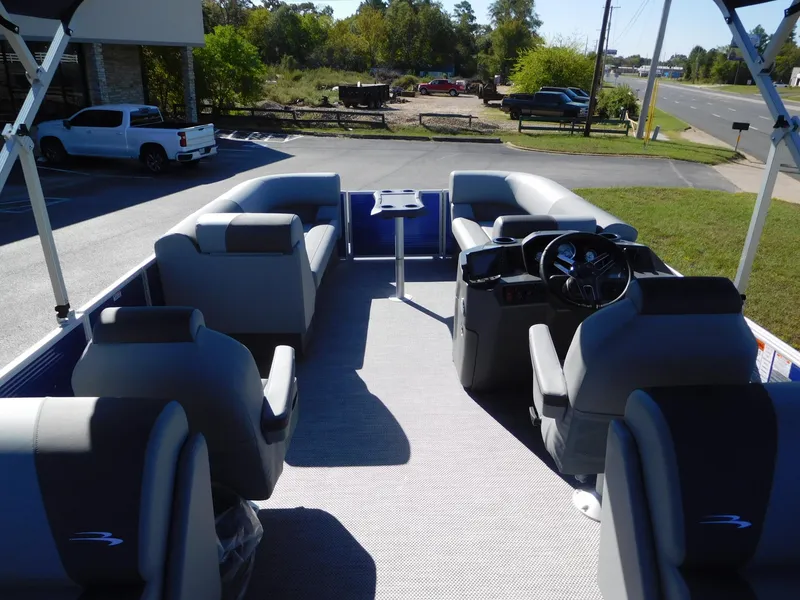 Slide: The Image of 2024 Bennington 22 SVSR pontoon boat interior with seating and steering console. - 7