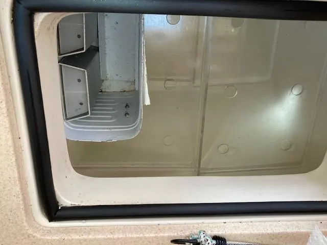 Slide: The Image of Storage compartment of a 2002 Catalina 34MK II sailboat, featuring organized shelving. - 14