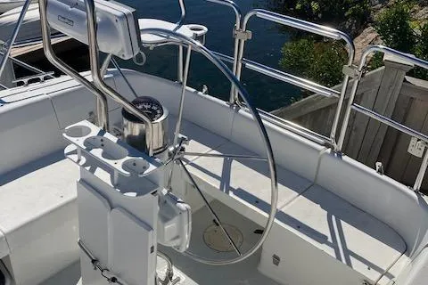 Slide: The Image of Steering wheel of a 2002 Catalina 34MK II sailboat, docked by the water. - 15