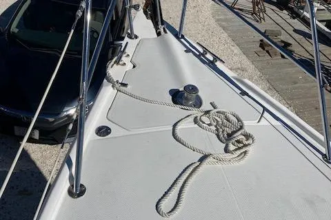Slide: The Image of 2002 Catalina 34MK II sailboat deck with coiled rope and winch. - 16