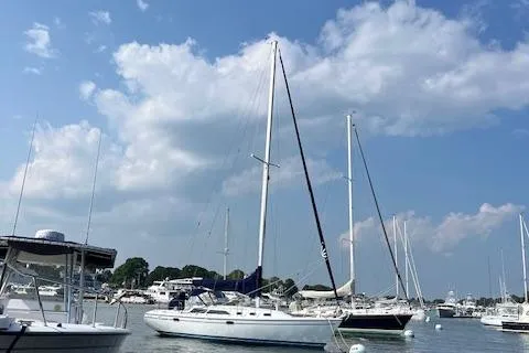Slide: The Image of 2002 Catalina 34MK II sailboat docked in a marina under a blue sky. - 2