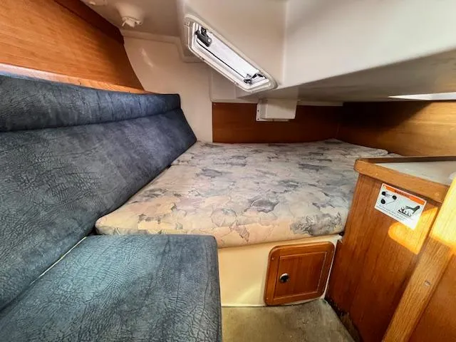 Slide: The Image of Cozy cabin interior of 2002 Catalina 34MK II sailboat with cushioned seating and bedding. - 21