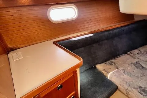 Slide: The Image of Interior of 2002 Catalina 34MK II sailboat with wood paneling and cushioned seating. - 22