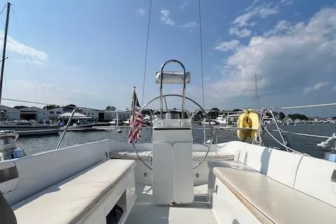 Slide: The Image of 2002 Catalina 34MK II sailboat cockpit with steering wheel, marina background, and clear sky. - 23