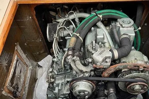 Slide: The Image of Engine compartment of a 2002 Catalina 34MK II sailboat, showcasing mechanical components and hoses. - 25