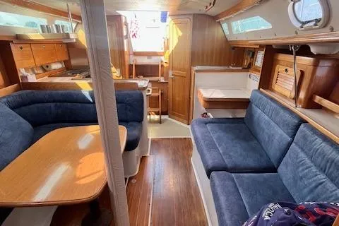 Slide: The Image of Interior of 2002 Catalina 34MK II sailboat with blue seating and wooden finishes. - 6