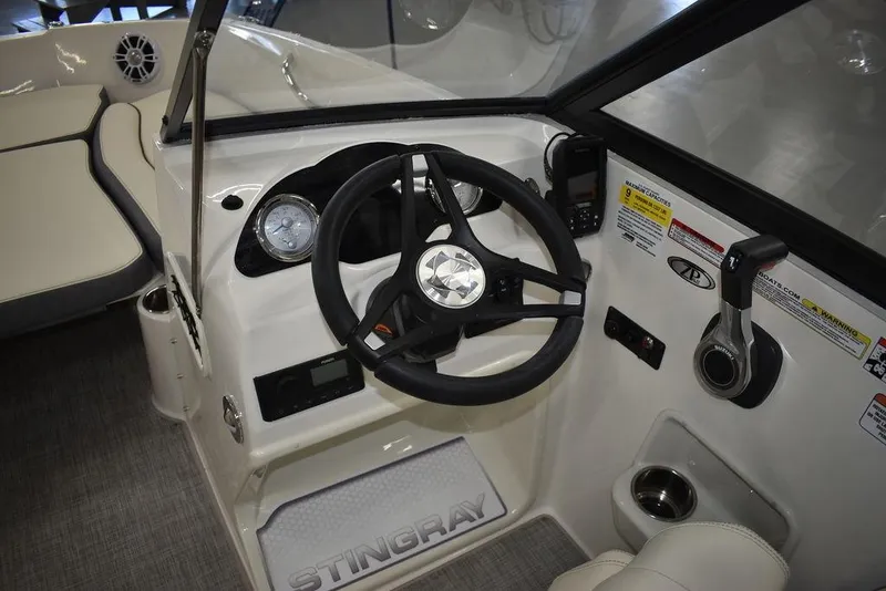 Slide: The Image of 2024 Stingray 191DC boat cockpit with steering wheel and controls. - 10
