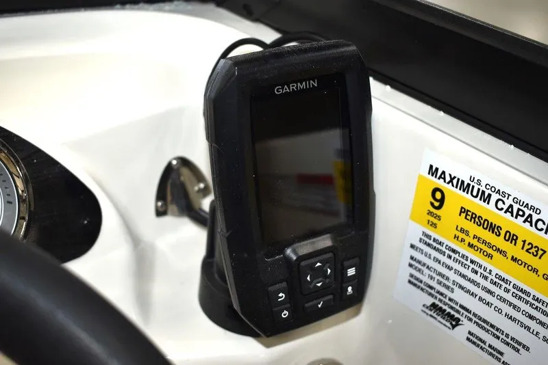 Slide: The Image of Garmin device on 2024 Stingray 191DC boat with maximum capacity label. - 13