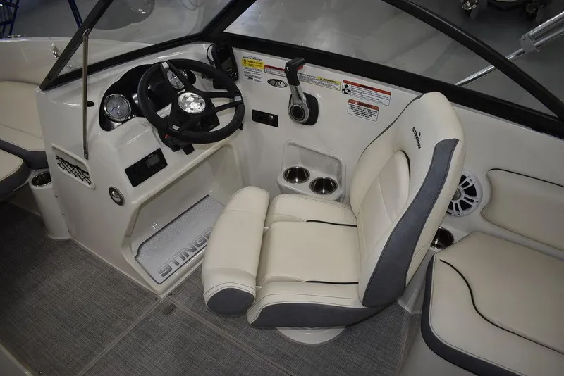 Slide: The Image of 2024 Stingray 191DC boat interior with steering wheel and captain's chair. - 16