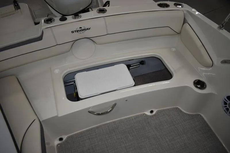 Slide: The Image of 2024 Stingray 191DC boat interior with storage compartment and seating. - 19