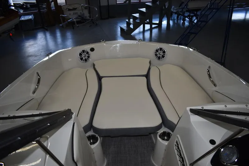 Slide: The Image of 2024 Stingray 191DC boat interior with cushioned seating and cup holders. - 24