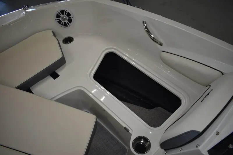 Slide: The Image of 2024 Stingray 191DC boat interior with storage compartment and cushioned seating. - 28