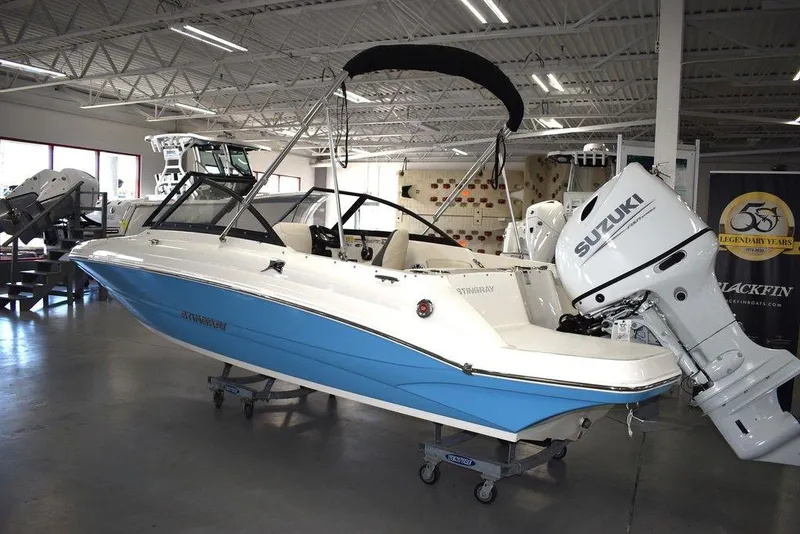 Slide: The Image of 2024 Stingray 191DC boat with Suzuki outboard motor in showroom. - 3