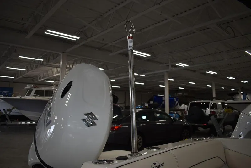 Slide: The Image of 2024 Stingray 191DC boat in showroom with Suzuki outboard motor. - 30