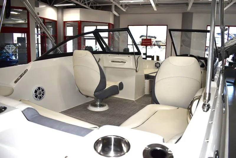 Slide: The Image of 2024 Stingray 191DC boat interior with beige and gray seating. - 5