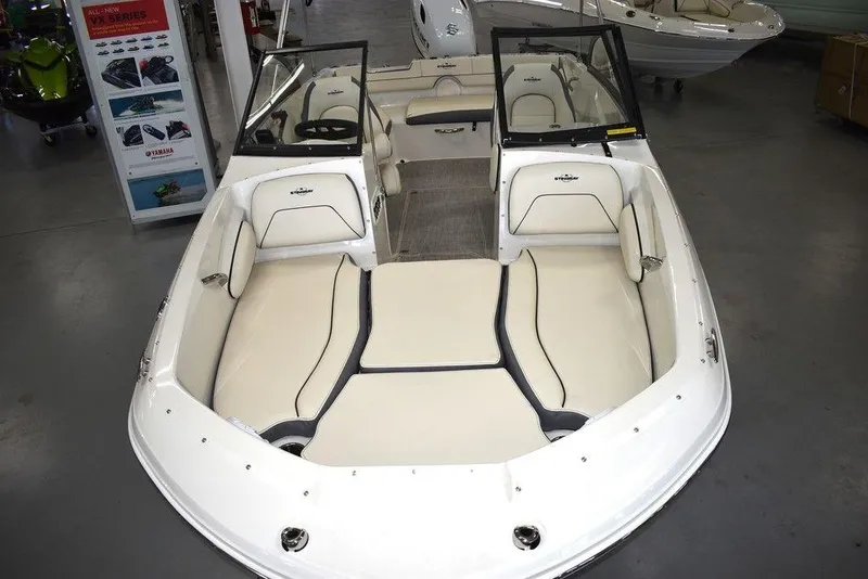Slide: The Image of 2024 Stingray 191DC boat with spacious seating and modern design in showroom. - 7