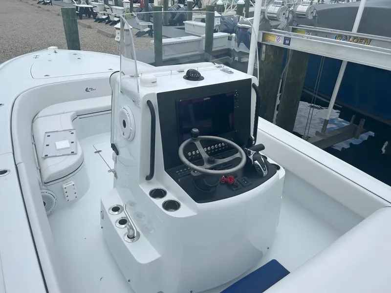 Slide: The Image of 2022 Contender 25 Bay boat console with steering wheel and controls. - 13