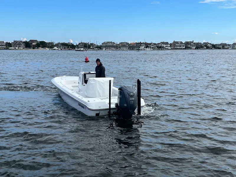Slide: The Image of 2022 Contender 25 Bay boat cruising on a coastal waterway. - 4