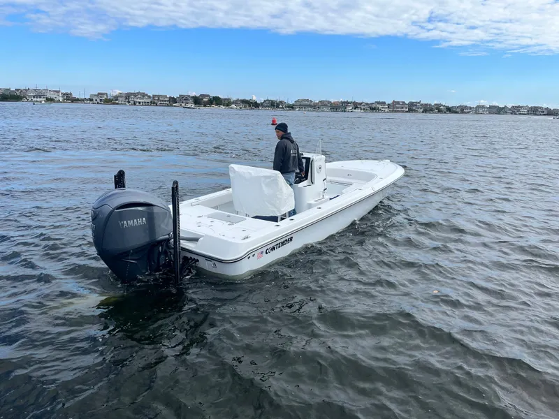 Slide: The Image of 2022 Contender 25 Bay boat on water with Yamaha outboard motor. - 5