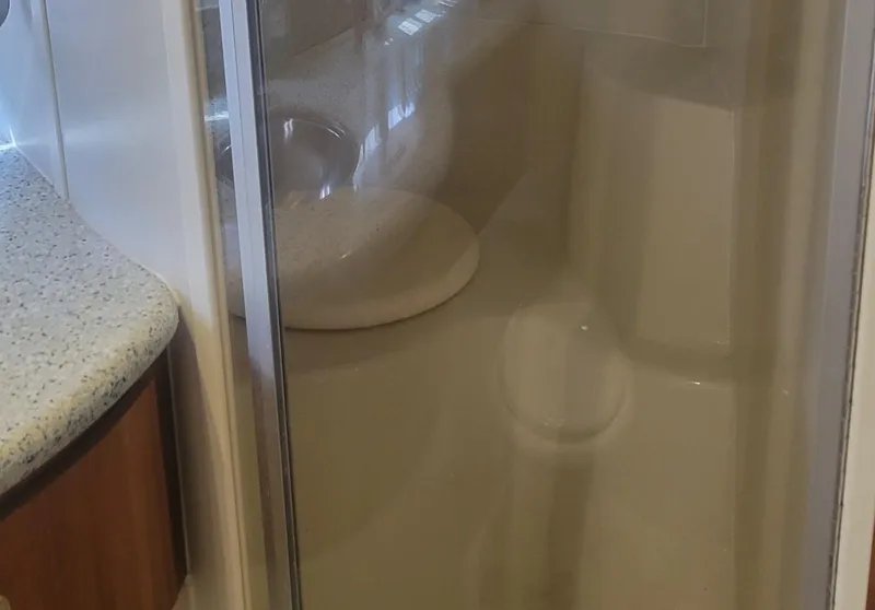 Slide: The Image of 2001 Carver 396 Motor Yacht bathroom with shower and countertop. - 10