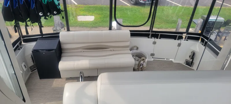 Slide: The Image of Interior of 2001 Carver 396 Motor Yacht with seating and mini fridge. - 11