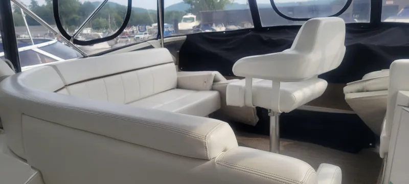 Slide: The Image of Interior seating of a 2001 Carver 396 Motor Yacht with white leather upholstery. - 12