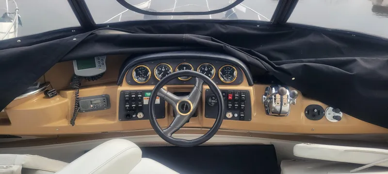 Slide: The Image of 2001 Carver 396 Motor Yacht helm with steering wheel, gauges, and controls. - 13