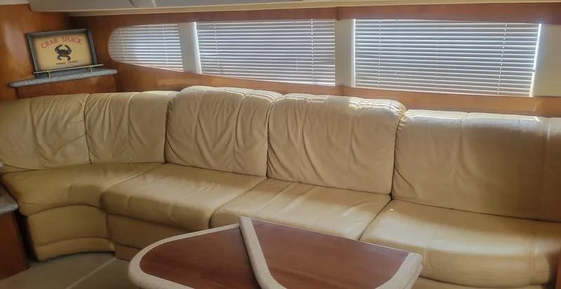 Slide: The Image of Interior of 2001 Carver 396 Motor Yacht with beige leather sofa and wooden table. - 6