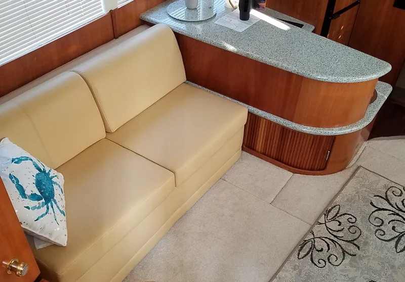Slide: The Image of Interior of 2001 Carver 396 Motor Yacht with beige sofa and granite countertop. - 7