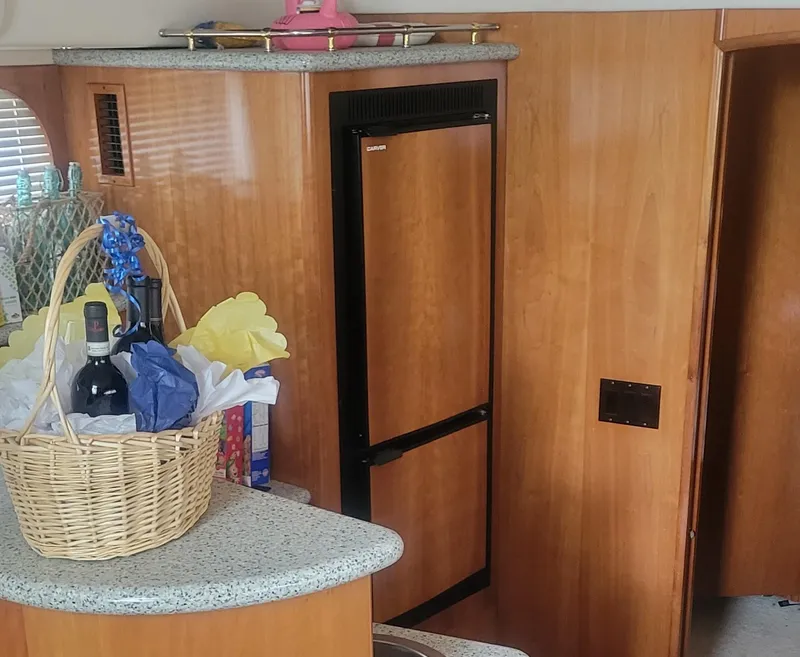 Slide: The Image of Interior of 2001 Carver 396 Motor Yacht with fridge and gift basket. - 8