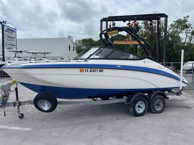 Slide: The Image of 2018 Yamaha Boats AR210 on trailer in marina. - 1