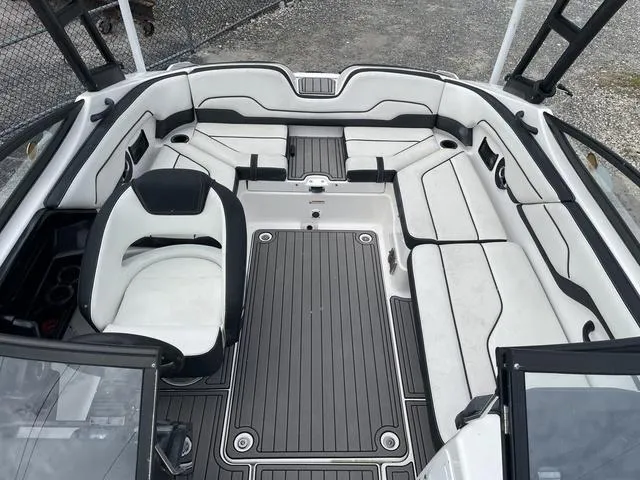 Slide: The Image of 2018 Yamaha Boats AR210 interior with white and black seating. - 11