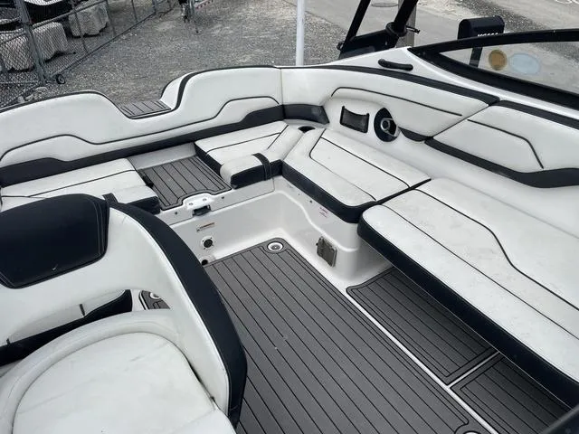 Slide: The Image of 2018 Yamaha Boats AR210 interior seating area with white and black upholstery. - 13