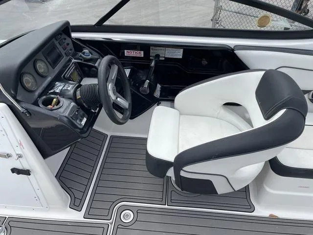 Slide: The Image of 2018 Yamaha Boats AR210 cockpit with steering wheel and captain's chair. - 16