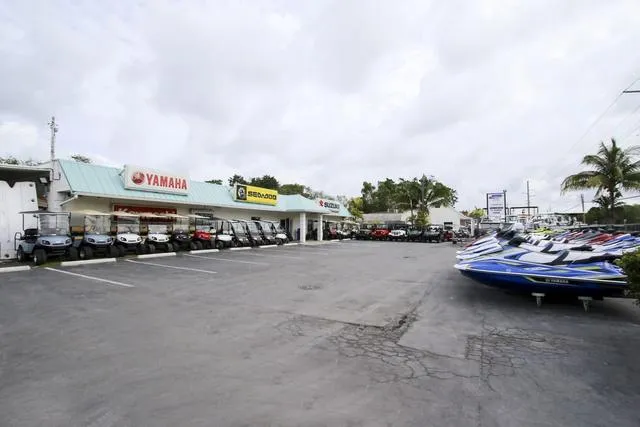Slide: The Image of Outdoor dealership showcasing Yamaha Boats, including the 2018 AR210 model, and various watercraft. - 27