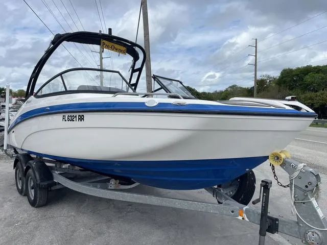 Slide: The Image of 2018 Yamaha Boats AR210 on trailer, pre-owned, white and blue, side view. - 3