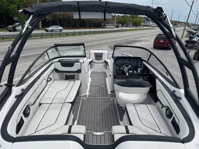 Slide: The Image of 2018 Yamaha Boats AR210 interior view, spacious seating, modern dashboard, and sleek design. - 6