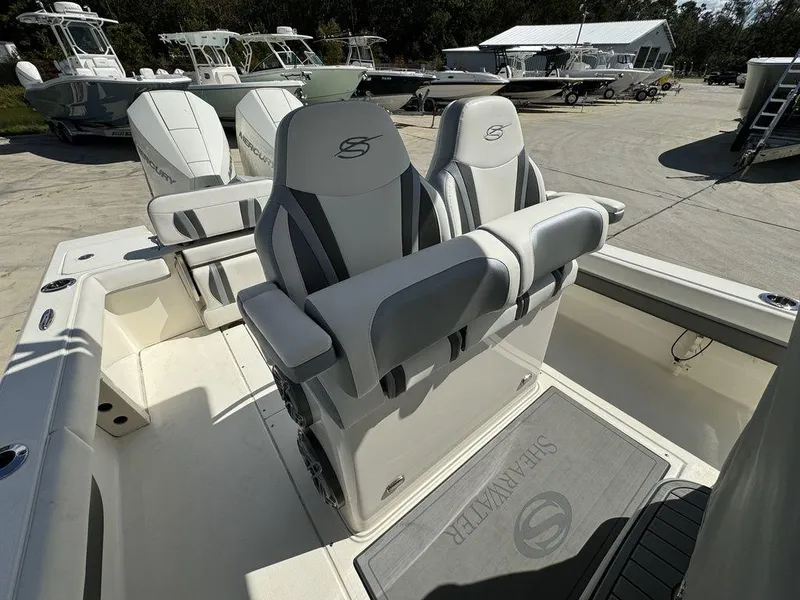 Slide: The Image of 2023 ShearWater 270 Carolina Open boat with dual captain's chairs and spacious deck. - 10