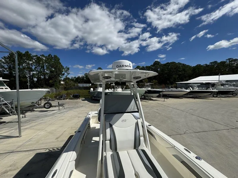 Slide: The Image of 2023 ShearWater 270 Carolina Open boat at a marina under a blue sky. - 16