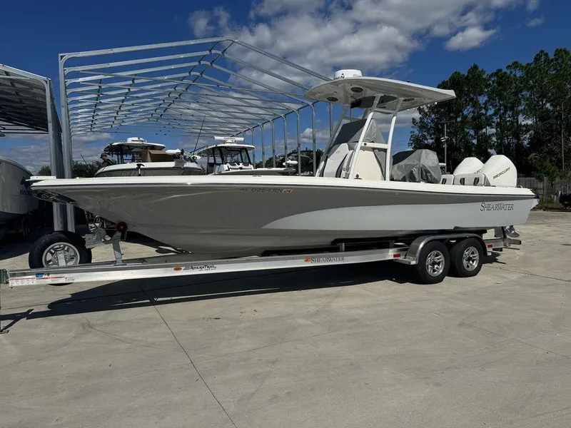 Slide: The Image of 2023 ShearWater 270 Carolina Open boat on a trailer in a marina. - 3