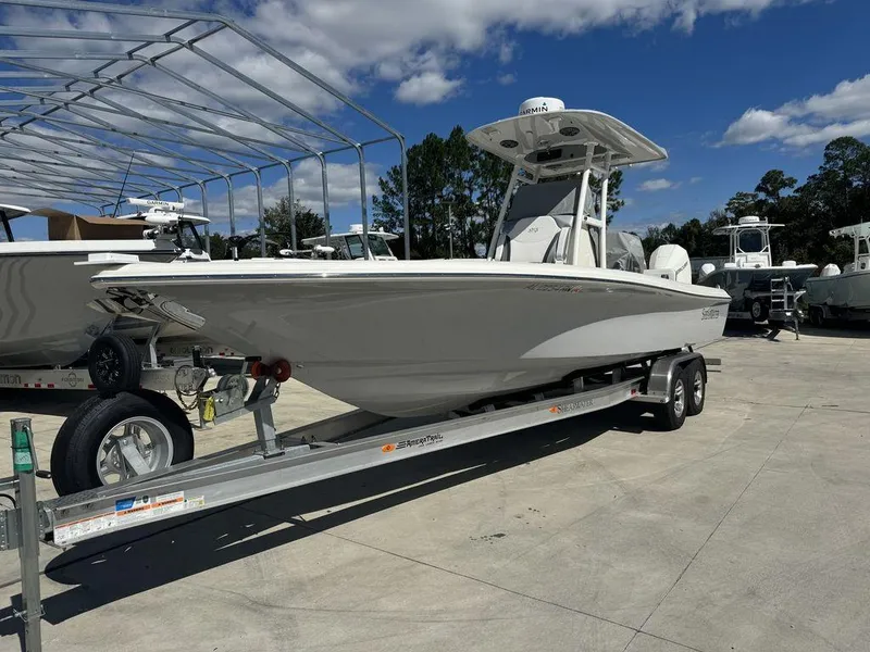 Slide: The Image of 2023 ShearWater 270 Carolina Open boat on a trailer in a marina. - 4