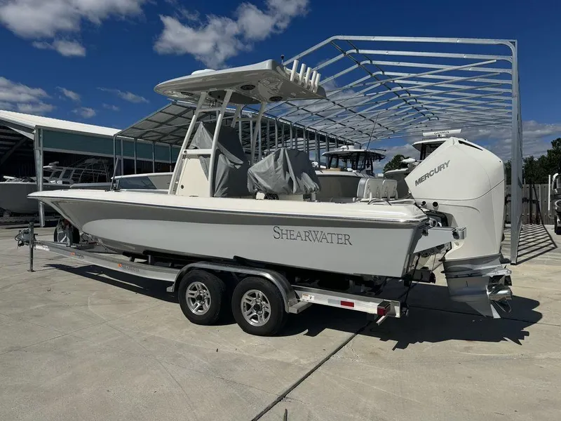 Slide: The Image of 2023 ShearWater 270 Carolina Open boat on a trailer with Mercury outboard motor. - 5