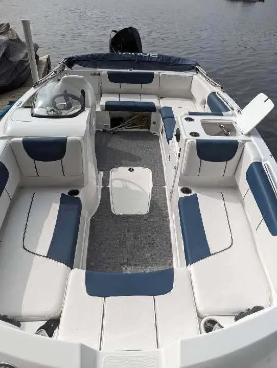 Slide: The Image of 2022 Tahoe 2150 boat with spacious seating and modern design on the water. - 10