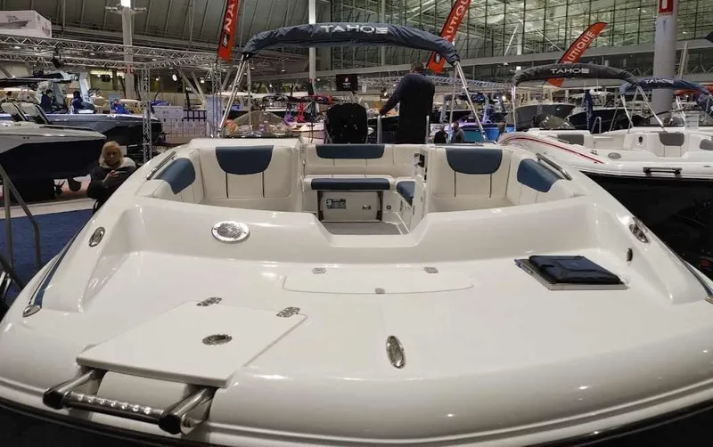 Slide: The Image of 2022 Tahoe 2150 boat on display at a boat show. - 3