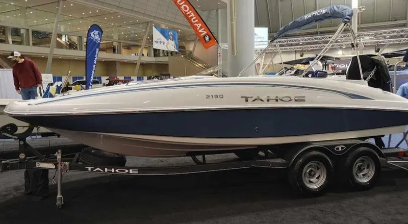 Slide: The Image of 2022 Tahoe 2150 boat on display at an indoor boat show. - 5