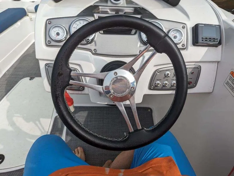 Slide: The Image of Steering wheel and dashboard of a 2022 Tahoe 2150 boat. - 6