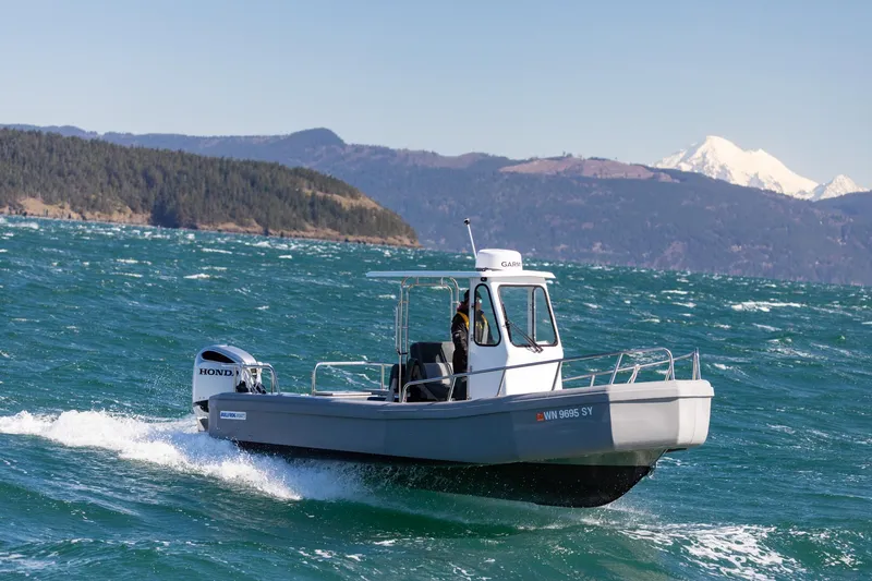 Slide: The Image of 2022 Bullfrog 22' Offshore Ranger boat cruising on open water with scenic mountain backdrop. - 4