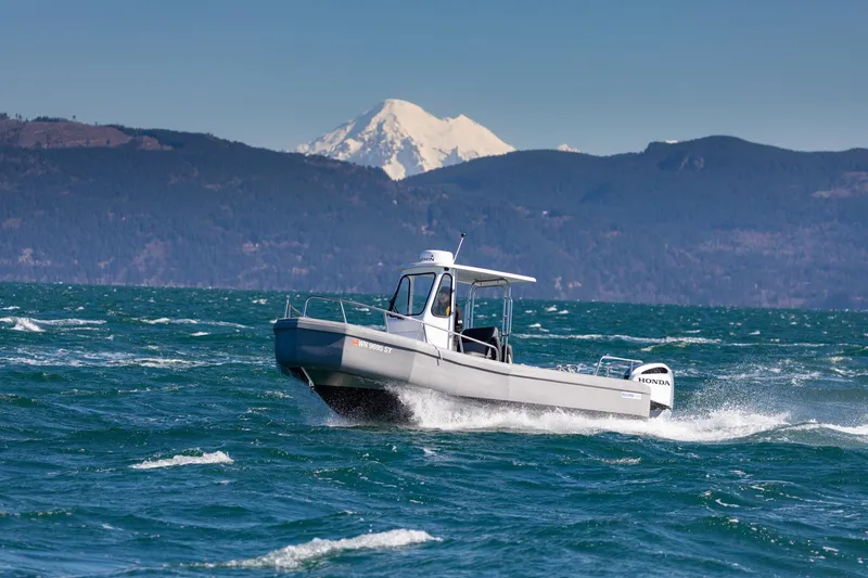 The Image of 2022 Bullfrog 22' Offshore Ranger boat cruising on a scenic lake with mountains in the background. - 1